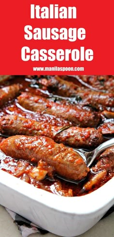 italian sausage casserole in a white baking dish with spoons and red background