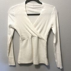 Nwot Cute Medium/Light Faux Wrap Sweater. A Deep White Or Light Cream Color. Sexy Deep V Neck But Stops Before Bra Line Or Just Top Of Brawhich Can Be Super Cute 22” Sleeve 15” Pit To Pit 22” Shoulder To Hem Tapers At Waist To 11” But It’s Very Stretchy So It Just Hugs Curves. Great With High Waisted Jeans Or Add Feminine Flare To New Baggie Pant Look. Does Not Feel Tight, Just Hugs In All The Right Places. Pet/Smoke Free Home Light Cream Color, High Waisted Jeans, Light Cream, Wrap Sweater, Cotton Lights, Shoulder Sweater, Deep V Neck, High Waist Jeans, Deep V