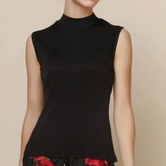 Badgley Mischka Sleeveless Mock Top In Black. A Versatile Classic You Can Wear Dressed Up Or Down, With Jeans, Trousers Or Skirt. Always Appropriate And Suitable For Most Climates All Year Round. Rear Neck Button Closure Mock Neck Wide Shoulders Sleeveless Black Final Sale Lowest Price Listed Sorry Offers Ignored Chic High Neck Tank Top For Night Out, Black Turtleneck Tank Top For Spring, Black High Neck Tank Top For Night Out, Chic Black Turtleneck Tank Top, Elegant Fitted Sleeveless Top, Elegant High Neck Tank Top For Party, Elegant Stretch Vest Tops, Elegant Sleeveless Stretch Tops, Elegant Fitted Turtleneck Tank Top