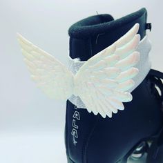 a pair of blue boots with white wings on them