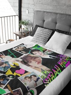 a bed with a blanket that has photos on it