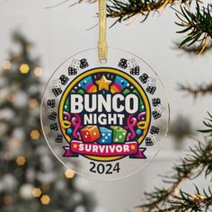 an ornament hanging from a christmas tree with the words bunco night survivor on it