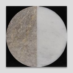 two circular pieces of marble on a black and white background