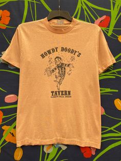 howdy doody tavern, bar, Klamath Falls, Oregon, single stage T-shirt, same in pink T-shirt with single stitch Vintage, single-stitch, t-shirt, vintage shirt, vintage streetwear, retro single stitch, vintage graphic, retro graphic print, retro print abstract graphic, band graphic, graphic t-shirt, graphic shirt,vintage graphic Vintage Short Sleeve T-shirt For Western-themed Events, Klamath Falls Oregon, Ventriloquist Doll, Howdy Doody, Stitch Tshirt, Doll Cartoon, Klamath Falls, Cartoon T Shirt, Abstract Graphic