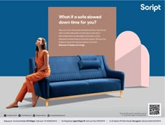 a woman sitting on top of a blue couch