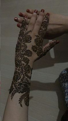 two hands with henna designs on them