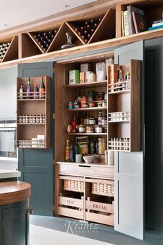 an open cabinet in a kitchen filled with spices