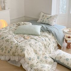 a bed with blue and white comforters in a bedroom next to a fireplace area