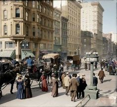 an old black and white photo of people walking down the street with horse drawn carriages