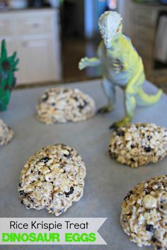 rice krispie treat dinosaur eggs on a baking sheet with an image of a toy t - rex