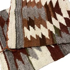 two rugs with different colors and patterns on them, one is white and the other is brown