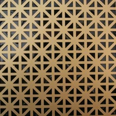 a close up view of a metal surface with geometric designs in gold and black colors