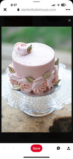 a pink cake sitting on top of a glass plate