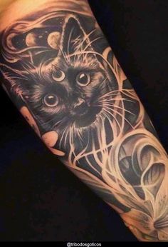 a black and white cat tattoo on the arm