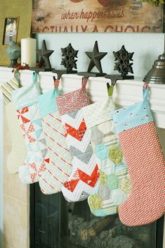 christmas stockings hung on a fireplace mantel