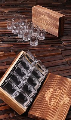 a wooden box filled with glasses on top of a table