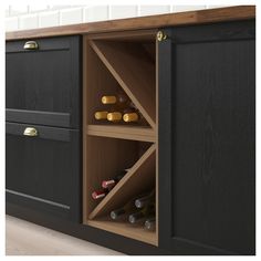 an open cabinet with wine bottles in it