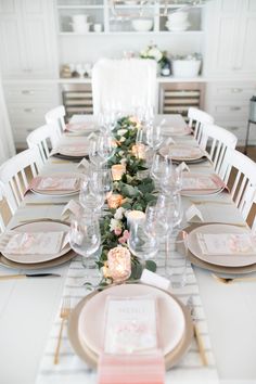 the table is set with plates and place settings