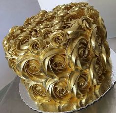 a golden rose cake on a white plate