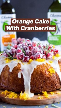 a bundt cake with icing, cranberries and orange zest on top