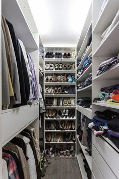 the closet is full of shoes and other things to wear in it's storage area