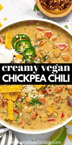 creamy vegan chickpea chili in a white bowl with tortilla chips on the side