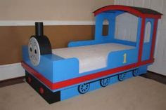 a child's bed made to look like a thomas the tank engine train car