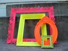 two different colored frames sitting on the ground next to each other, one with an orange ring