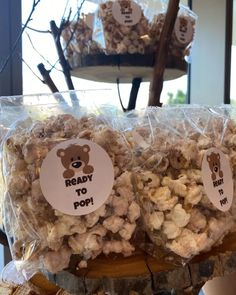 two bags of popcorn sitting on top of a table