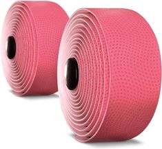 two rolls of pink exercise yoga mat with black holes on the side and one roll is rolled up