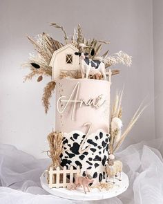 a cake decorated with farm animals and letters