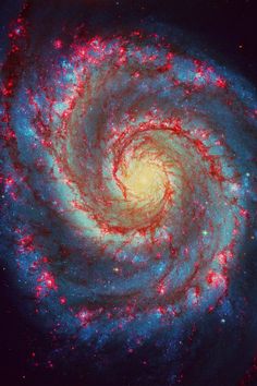 two spiral shaped objects in the sky, one red and one blue with stars on it