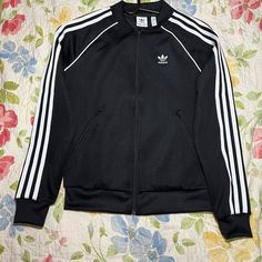 Adidas Adicolor Classics Primeblue Sst Track Jacket In Black Size Xs. Has Adidas Logo On The Front. Adidas Detailing On Zipper. Never Worn, Perfect Condition. Smoke-Free And Pet-Free Home. Clothing Hanger Not Included. Adidas Sst, Y2k Coat, Clothing Hanger, Adidas Adicolor, Home Clothing, Adidas Track