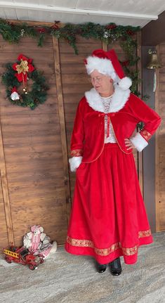 an older woman in a red dress and santa hat