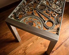 a metal table topped with lots of gears