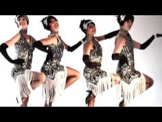 three women dressed in silver and black are dancing with their hands on their hipss