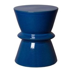 a blue stool sitting on top of a white floor