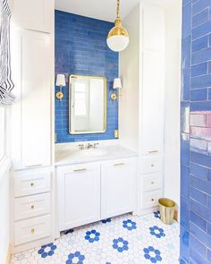 a bathroom with blue and white tiles on the walls