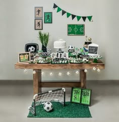 a table with soccer themed items and decorations