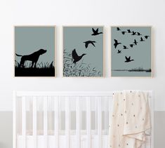 three black and white prints on the wall above a crib