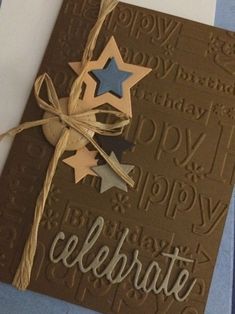 a close up of a greeting card with paper stars on it and the words happy birthday written in cursive writing