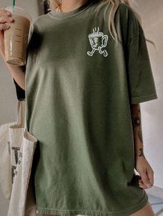 These tees are printed on super soft Comfort Colors, providing a relaxed unisex fit with a worn-in look and feel. This collection offers our most expanded size range from S-3X.Looking for these tees to fit oversized? Size up 1-2 sizes.Model is wearing a size XL for an oversized fit• 100% ring-spun cotton• Garment-dyed• Relaxed fitThis product is made especially for you as soon as you place an order, please see the banner on the top of our site for current turnaround times. Making products on dem Casual Green T-shirt For Everyday, Comfortable Graphic Print T-shirt, Comfortable Crew Neck T-shirt With Letter Print, Crew Neck T-shirt With Letter Print For Loungewear, Graphic Tee With Front Print In Ring-spun Cotton, Everyday Screen Print T-shirt In Ring-spun Cotton, Oversized Casual T-shirt For Loungewear, Short Sleeve T-shirt With Letter Print For Loungewear, Trendy Relaxed Fit T-shirt For Loungewear