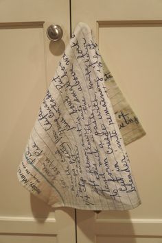 two pieces of paper with writing on them hanging from a hook in front of a door