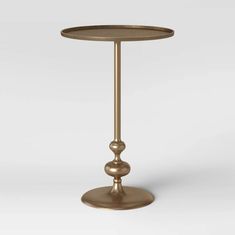 a gold metal table with two balls on the top and one ball at the base