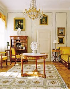 a living room filled with furniture and a chandelier