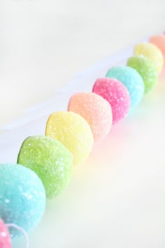 a row of colored candies sitting on top of a white counter