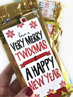 someone is holding up a new year's candy bar wrapper with the words merry, twixmas and a happy new year on it