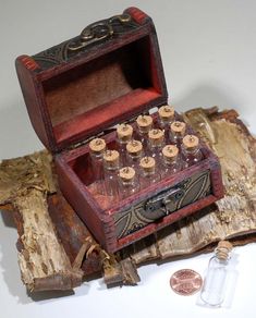 an old fashioned wooden box with bottles in it next to some coins and a bottle opener