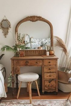 a bedroom with a dresser, mirror and stool