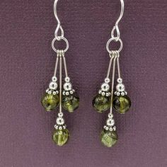 "Sterling silver with three peridot beads and handmade Bali sterling silver dangles.  These lovely earrings are 1 7/8\" long, from the top of the earwire to the bottom of the center dangle. Peridot is a birthstone for August and it's also a gift for a first wedding anniversary. Your earrings will arrive in a  decorated gift box with a pair of little rubber stoppers for the earwires, so you won't lose your earrings. Your jewelry will be shipped in recycleable envelope that can be recycled with yo Earrings Handmade Greatergood, Earing Ideas Beads, Diy Earring Ideas Homemade, Beaded Jewelry Designs Ideas, Beaded Jewelry Inspiration, Bead Earrings Ideas, Earring Design Ideas, Diy Dangle Earrings, Handmade Earrings Ideas